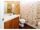 Bathroom featuring a vanity with a sink, toilet, and a shower/tub combination with a seashell patterned curtain at 14027 Bensbrook Dr, Spring Hill, FL 34609
