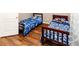 Cozy bedroom with two twin beds and wood floors provides a functional space for children or guests at 14027 Bensbrook Dr, Spring Hill, FL 34609
