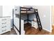 Bedroom featuring a dark wood loft bed with a ladder and built-in storage and dark wood floors at 14027 Bensbrook Dr, Spring Hill, FL 34609