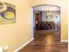 View of dining room through an archway showcasing ample seating and hardwood floors at 14027 Bensbrook Dr, Spring Hill, FL 34609