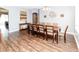 Spacious dining room featuring a large table, neutral decor, and hardwood floors at 14027 Bensbrook Dr, Spring Hill, FL 34609