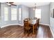 Dining room featuring a rustic wood table, chandelier and lots of natural light at 14027 Bensbrook Dr, Spring Hill, FL 34609