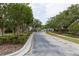 Community entrance with secure gate access and manicured greenery, ensuring privacy and aesthetic appeal at 14027 Bensbrook Dr, Spring Hill, FL 34609