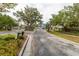Gated community entrance with mature landscaping and secure access, providing privacy and curb appeal at 14027 Bensbrook Dr, Spring Hill, FL 34609