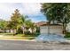 Charming single-story home featuring a well-manicured lawn, mature trees, and an attached two-car garage at 14027 Bensbrook Dr, Spring Hill, FL 34609