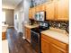 Stylish kitchen with stainless steel appliances, wood cabinets, and decorative backsplash at 14027 Bensbrook Dr, Spring Hill, FL 34609
