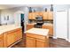 Well-equipped kitchen with wood cabinets, stainless steel appliances, and center island at 14027 Bensbrook Dr, Spring Hill, FL 34609