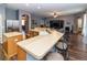 Open-concept kitchen with bar seating, stainless steel appliances, and views to the dining and living areas at 14027 Bensbrook Dr, Spring Hill, FL 34609