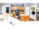 Bright kitchen features a central island, stainless appliances, and a pantry next to laundry at 14027 Bensbrook Dr, Spring Hill, FL 34609