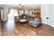 Spacious living room opens to the kitchen and dining area, featuring hardwood floors at 14027 Bensbrook Dr, Spring Hill, FL 34609