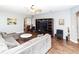 Comfortable living room features hardwood floors, ceiling fan, and entertainment center at 14027 Bensbrook Dr, Spring Hill, FL 34609