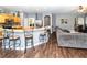 Open-concept living space with bar stool seating, modern flooring, and comfortable furnishings at 14027 Bensbrook Dr, Spring Hill, FL 34609