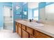 The bathroom features double sinks, neutral tile, and a glass-enclosed shower at 14027 Bensbrook Dr, Spring Hill, FL 34609