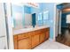 The bathroom features double sinks, neutral tile, and a glass-enclosed shower at 14027 Bensbrook Dr, Spring Hill, FL 34609