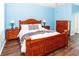 Charming bedroom features wood floors, a ceiling fan, and stylish decor at 14027 Bensbrook Dr, Spring Hill, FL 34609
