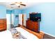 The bedroom features hardwood floors, a ceiling fan, and ample storage space at 14027 Bensbrook Dr, Spring Hill, FL 34609