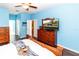 Charming bedroom features wood floors, a ceiling fan, and ample storage space at 14027 Bensbrook Dr, Spring Hill, FL 34609