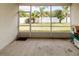 The screened patio with concrete floor offers an outdoor space with views of the backyard and landscaping at 14027 Bensbrook Dr, Spring Hill, FL 34609