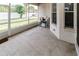 The screened patio with concrete floor offers an outdoor space with views of the backyard and landscaping at 14027 Bensbrook Dr, Spring Hill, FL 34609