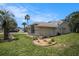 Side view of the home with a well-manicured lawn and landscaping beds, adding charm and character at 14181 Cornewall Ln, Spring Hill, FL 34609