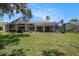 Enjoy an expansive backyard featuring a screened-in patio and plenty of room for outdoor activities at 14181 Cornewall Ln, Spring Hill, FL 34609