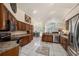 Bright, open kitchen with granite countertops, stainless steel appliances, and a decorative tile floor at 14181 Cornewall Ln, Spring Hill, FL 34609