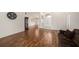 Open-concept living room with wood floors and access to the dining area and front entryway, creating an inviting space at 14181 Cornewall Ln, Spring Hill, FL 34609