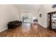 Bright living room with wood floors, sliding glass doors to the pool, and open layout connecting to the dining area at 14181 Cornewall Ln, Spring Hill, FL 34609