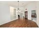 Open living room with wood floors and view to dining room and kitchen at 14181 Cornewall Ln, Spring Hill, FL 34609