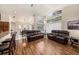 Bright and airy living room with wood floors, vaulted ceilings, and comfortable leather sofas overlooking the backyard at 14181 Cornewall Ln, Spring Hill, FL 34609