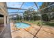 Enclosed pool area with a nice view of the property's surrounding landscape at 14181 Cornewall Ln, Spring Hill, FL 34609