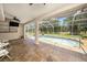 Enclosed pool area with plenty of lounging space and a view of the property's landscape at 14181 Cornewall Ln, Spring Hill, FL 34609