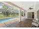 This covered pool boasts a spacious deck and an adjacent seating area, perfect for outdoor enjoyment at 14181 Cornewall Ln, Spring Hill, FL 34609