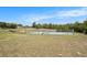 Scenic tennis courts with green fencing and lush greenery, providing a perfect space for active recreation at 14181 Cornewall Ln, Spring Hill, FL 34609