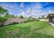 Expansive backyard with lush green lawn, mature landscaping, and privacy fence at 14341 Passage Way, Seminole, FL 33776