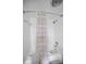 Clean bathroom featuring a shower-tub combo with chrome fixtures and neutral-toned shower curtain at 14341 Passage Way, Seminole, FL 33776