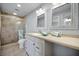 Bathroom features a tile shower, double vanity, and two large mirrors above the vanity at 14341 Passage Way, Seminole, FL 33776