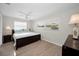 Bright bedroom with a ceiling fan, wood-look flooring, and large window at 14341 Passage Way, Seminole, FL 33776