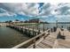 Community pier extending into the bay, featuring benches and picturesque views, ideal for leisurely strolls and contemplation at 14341 Passage Way, Seminole, FL 33776