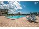Beautiful community pool with ample seating, umbrellas, and tropical landscaping at Imperial Point at 14341 Passage Way, Seminole, FL 33776