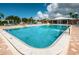 Inviting community pool with a clubhouse and seating areas for relaxation at Imperial Point at 14341 Passage Way, Seminole, FL 33776