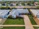 An inviting single-story home features a well-manicured lawn, a long driveway, and a classic brick facade at 14341 Passage Way, Seminole, FL 33776