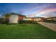 Well-manicured front yard of single-story home featuring a long driveway and lush green lawn at 14341 Passage Way, Seminole, FL 33776