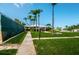 Well-maintained grounds with mature palm trees and lush landscaping, offering a serene and inviting community ambiance at 14341 Passage Way, Seminole, FL 33776