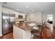 Modern kitchen with island, stainless steel refrigerator, and hardwood floors at 14341 Passage Way, Seminole, FL 33776