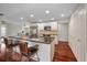 Spacious kitchen island with bar seating, stainless steel refrigerator, and modern appliances at 14341 Passage Way, Seminole, FL 33776