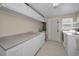 Laundry room with white cabinets, countertops and appliances at 14341 Passage Way, Seminole, FL 33776