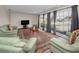 Spacious living room with large windows, comfortable seating, and a decorative rug at 14341 Passage Way, Seminole, FL 33776