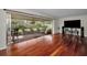 Open living space featuring hardwood floors, patio access, and an entertainment center at 14341 Passage Way, Seminole, FL 33776