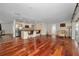 Open-concept living space featuring hardwood floors, kitchen, and access to outdoor patio at 14341 Passage Way, Seminole, FL 33776